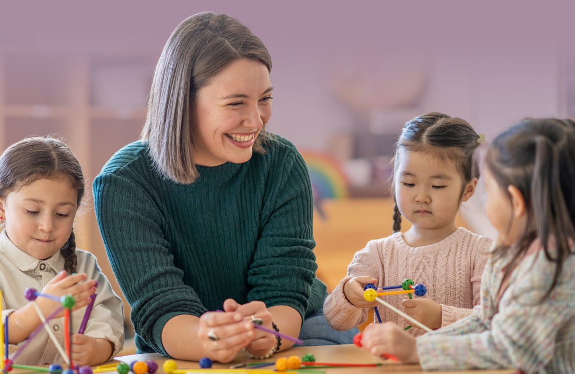 Teacher in classroom with smiling children